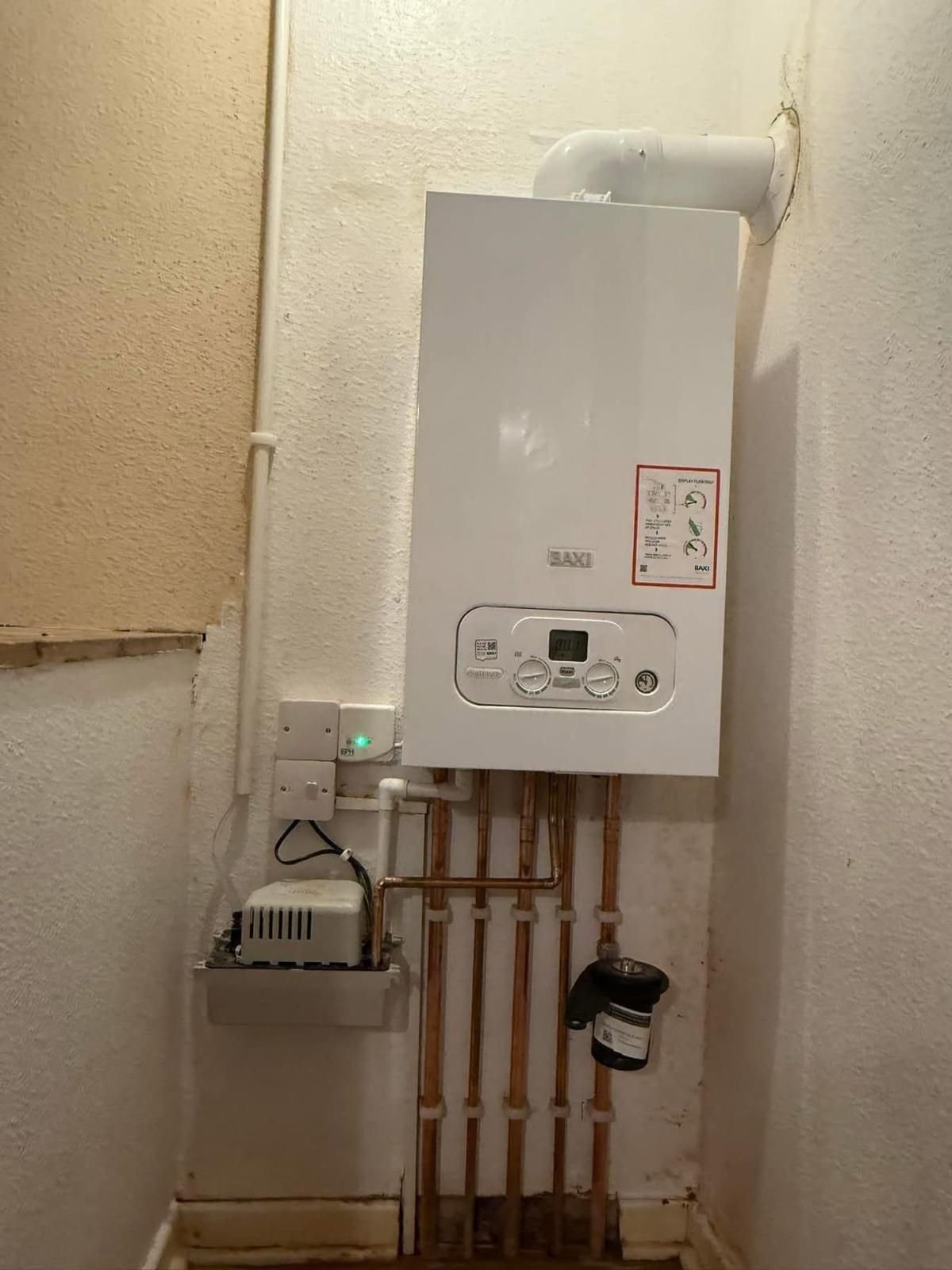 Baxi combi boiler installed in a hallway cupboard