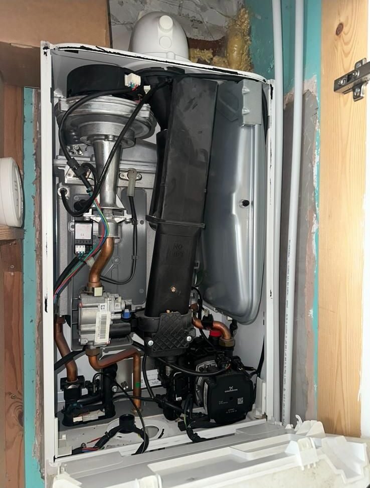 Combi boiler internals inspected during a service visit