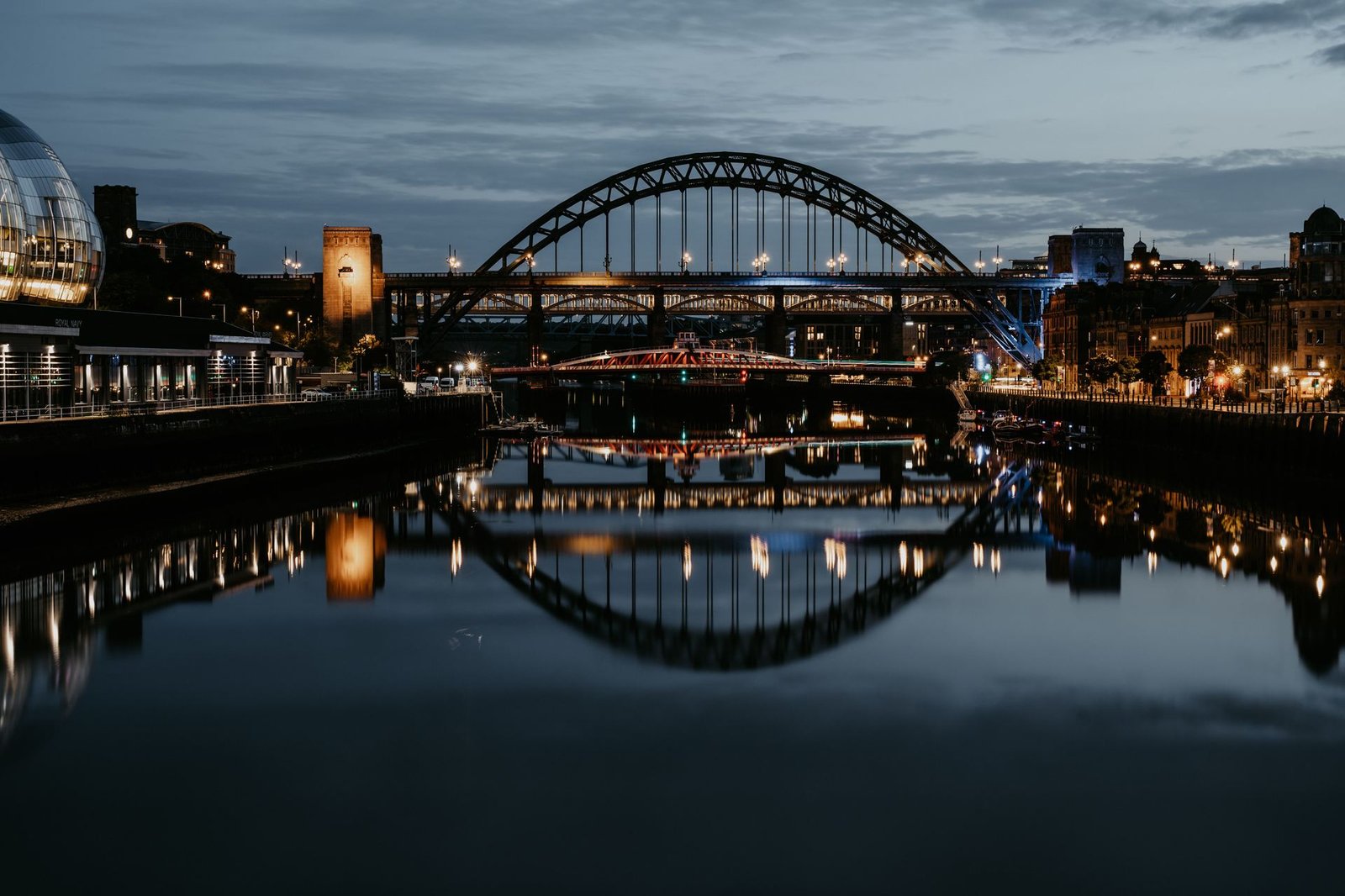 The Tyne Bridge and Newcastle Quayside reflected at night